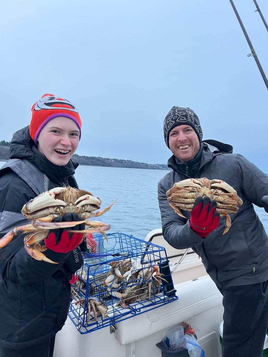 Two happy charter customers with a great haul of Dungeness crab in Seattle