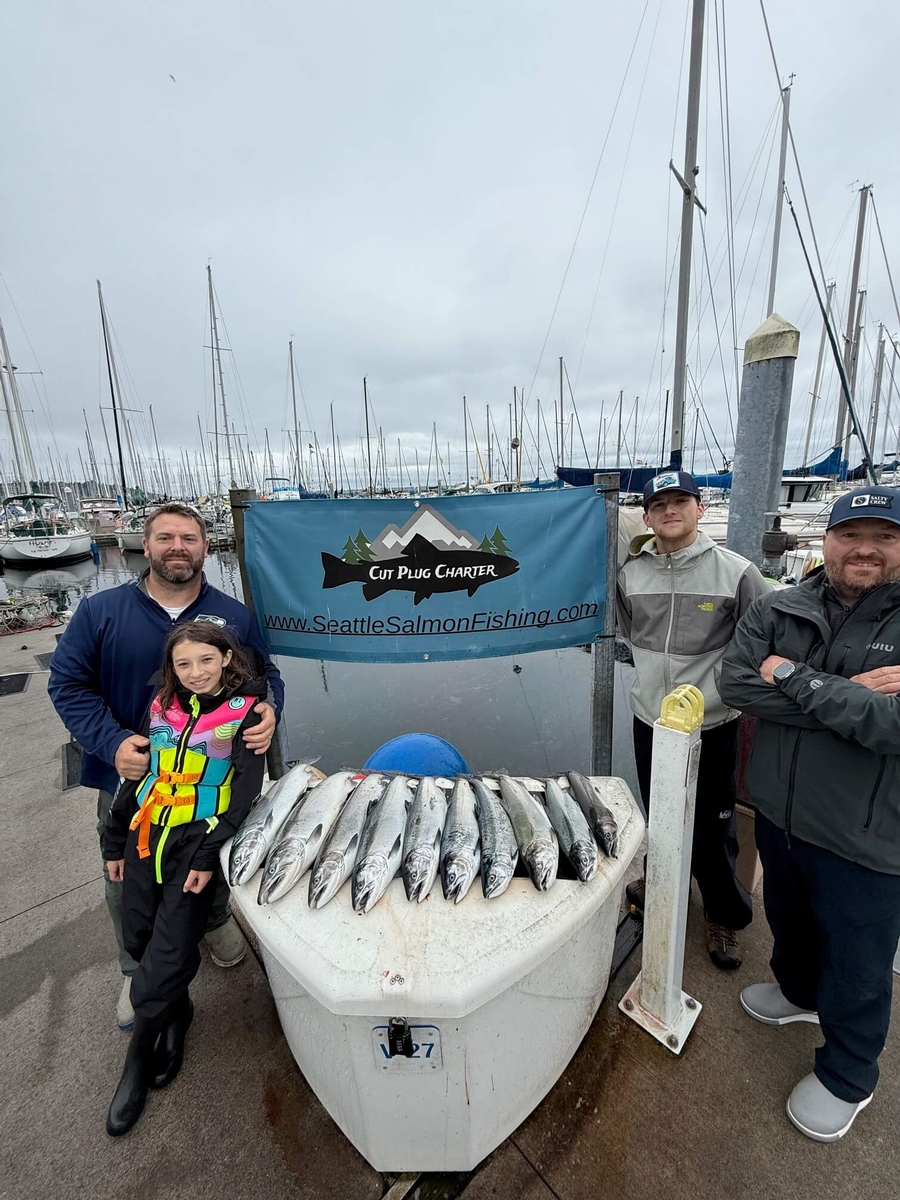 Happy customers of Cut Plug Charters with a great haul of Coho salmon from the Puget Sound in Seattle